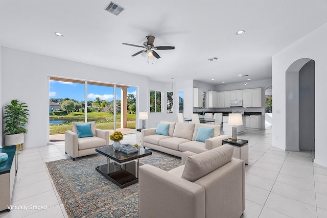 living room featuring light tile patterned flooring and ceiling fan