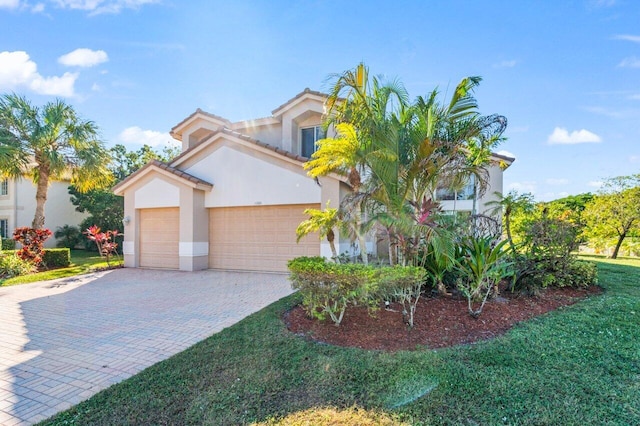 view of front of home with a garage and a front lawn