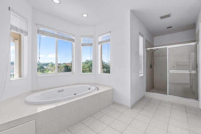 bathroom with separate shower and tub and tile patterned floors