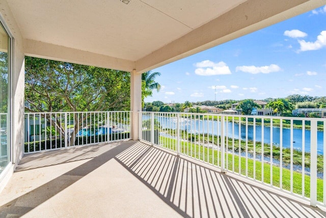 view of patio / terrace with a water view and a balcony