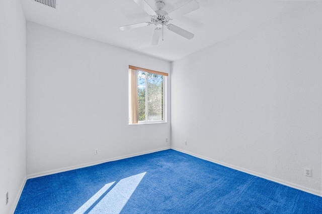 carpeted spare room featuring ceiling fan