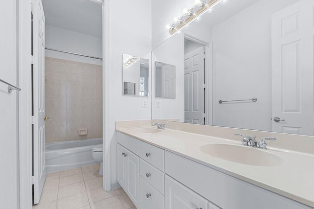 full bathroom featuring toilet, vanity, tiled shower / bath combo, and tile patterned floors