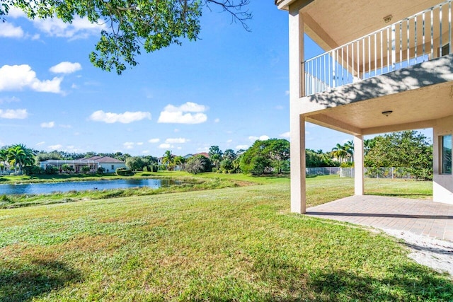 view of yard with a patio and a water view