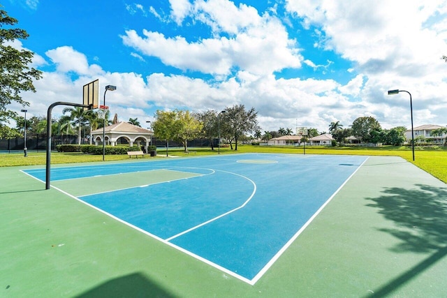 view of basketball court featuring a yard