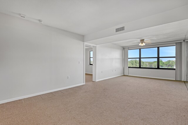 spare room featuring ceiling fan and light colored carpet