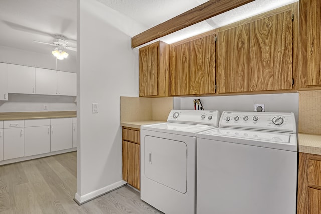 laundry area with ceiling fan, cabinets, separate washer and dryer, and light wood-type flooring