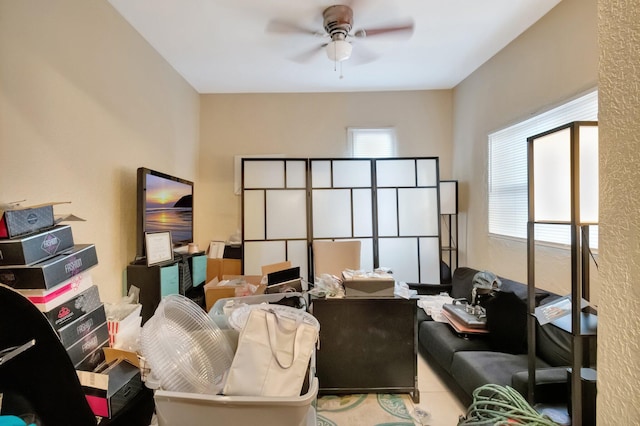 interior space featuring ceiling fan and light tile patterned flooring