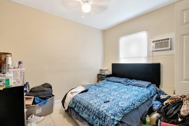 tiled bedroom with ceiling fan and a wall mounted air conditioner