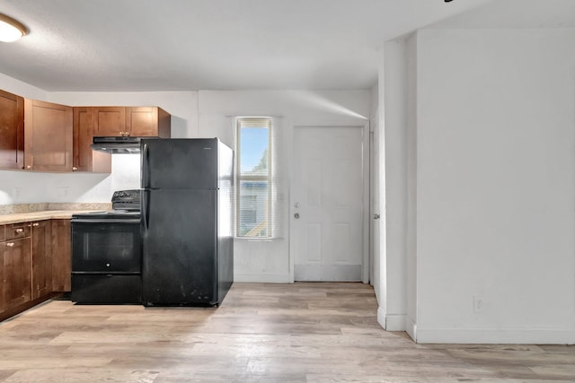 kitchen featuring black appliances and light hardwood / wood-style flooring