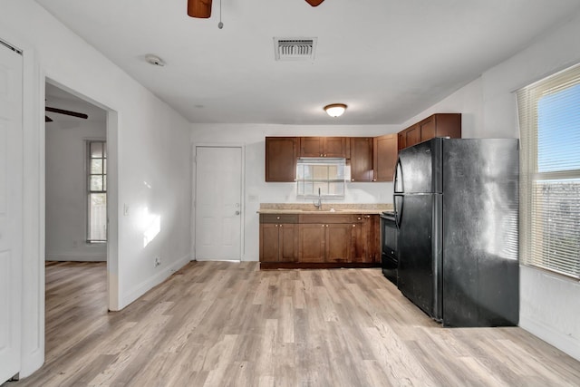 kitchen featuring ceiling fan, sink, black appliances, and light wood-type flooring