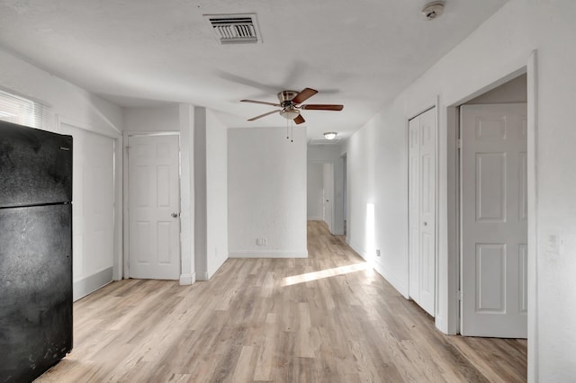 unfurnished living room with ceiling fan and light wood-type flooring