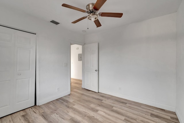 unfurnished bedroom with ceiling fan, a closet, and light hardwood / wood-style floors