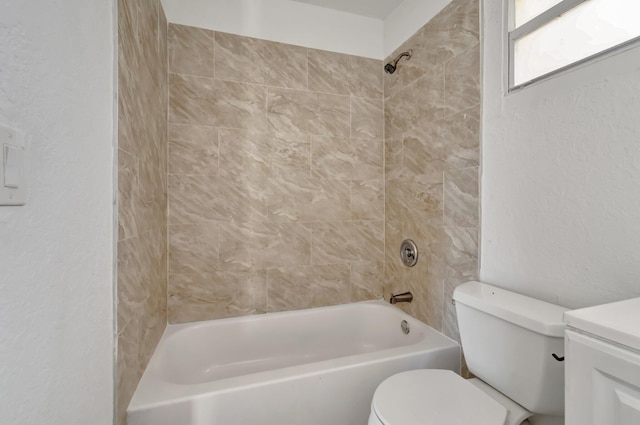 bathroom featuring toilet and tiled shower / bath