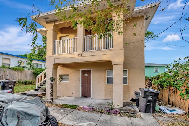 view of front of property with a patio area and a balcony