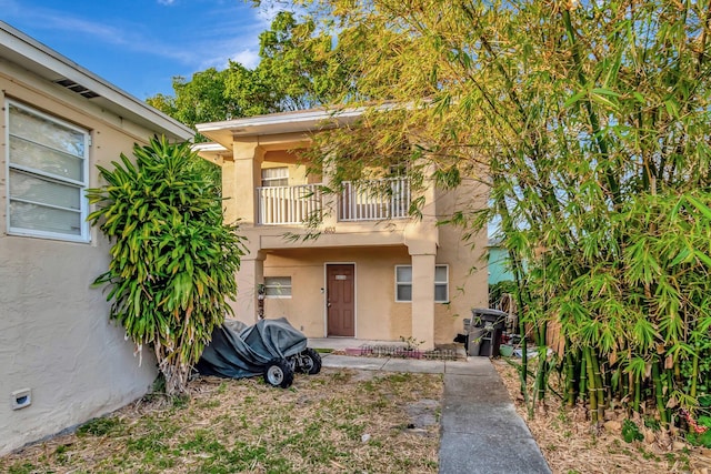 view of front of property with a balcony