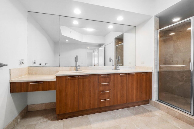 bathroom with a shower with door and vanity