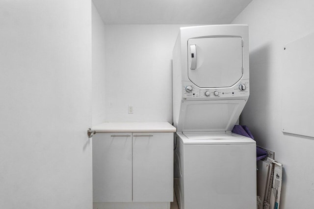 clothes washing area with stacked washer and clothes dryer