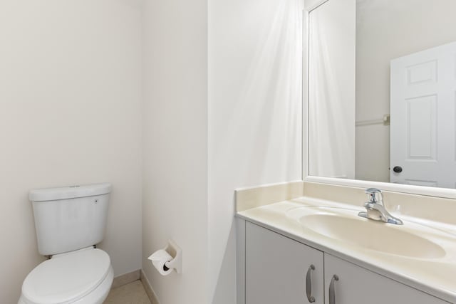 bathroom featuring vanity and toilet