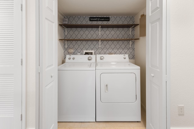 washroom featuring washing machine and dryer and light tile patterned flooring