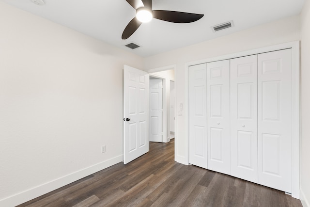 unfurnished bedroom featuring a closet, ceiling fan, and dark wood-type flooring