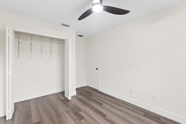 unfurnished bedroom with a closet, ceiling fan, and dark hardwood / wood-style flooring