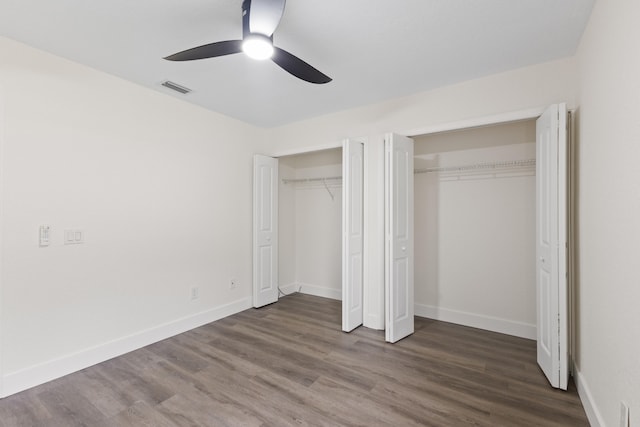 unfurnished bedroom featuring ceiling fan and dark hardwood / wood-style floors