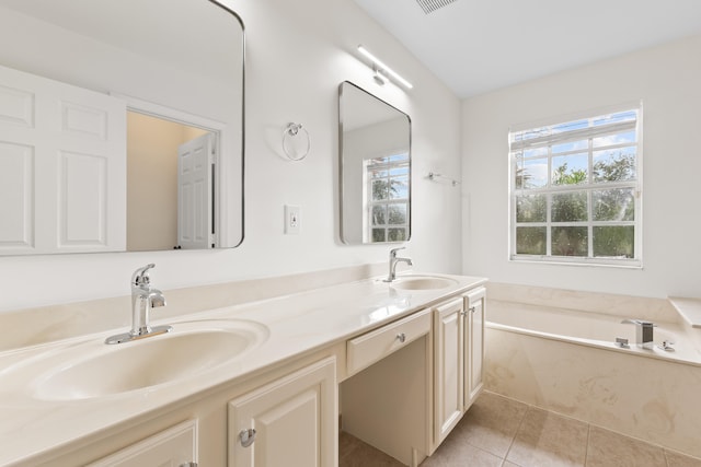 bathroom featuring tile patterned floors, vanity, and a tub to relax in