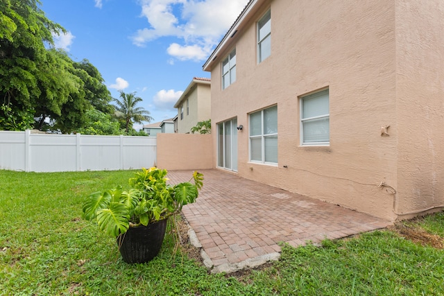 exterior space featuring a patio area and a lawn