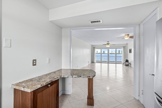 hall with light tile patterned floors