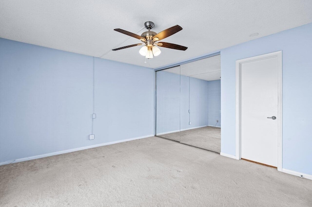 unfurnished bedroom with ceiling fan, a closet, and light carpet