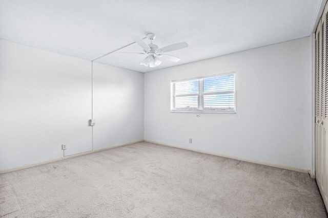 unfurnished room featuring carpet flooring, a textured ceiling, and ceiling fan