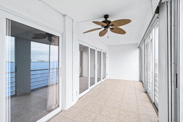 unfurnished sunroom with a water view