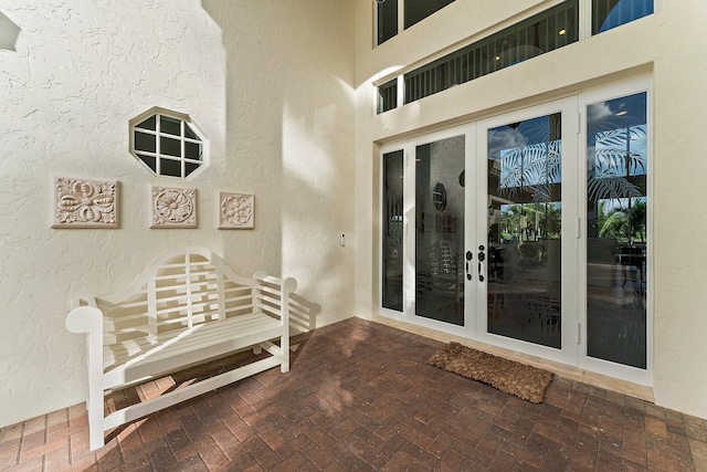 entrance to property featuring a patio area and french doors