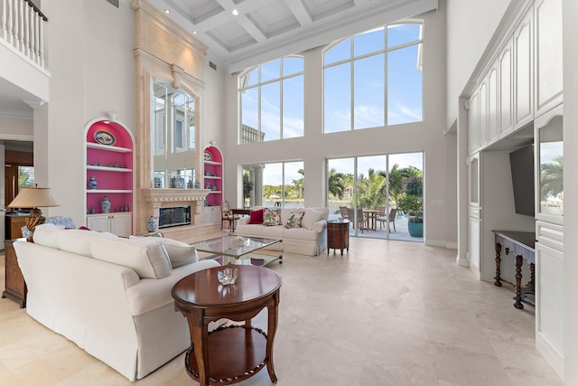 living room with a high ceiling, coffered ceiling, a premium fireplace, ornamental molding, and beamed ceiling