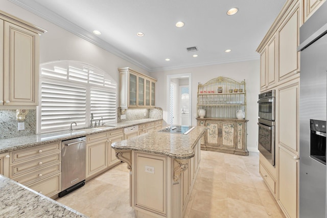 kitchen featuring decorative backsplash, appliances with stainless steel finishes, a kitchen island, and light stone countertops