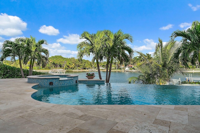 view of pool with a water view and an in ground hot tub