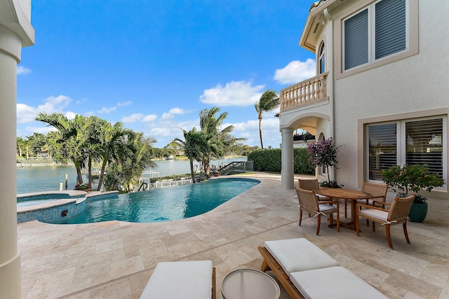 view of pool with a water view, an in ground hot tub, and a patio