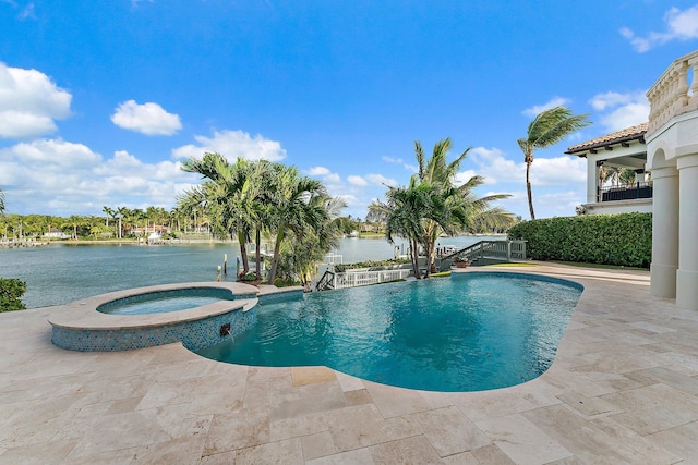 view of pool featuring a patio area, a water view, and an in ground hot tub