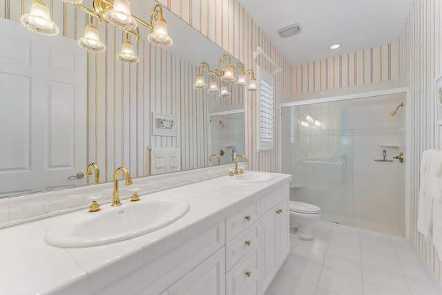 bathroom with tile patterned flooring, vanity, a shower with shower door, and toilet