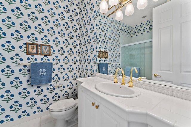 bathroom featuring tile patterned floors, vanity, toilet, and an enclosed shower