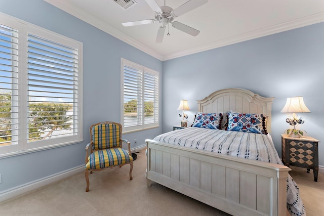 carpeted bedroom featuring ceiling fan and crown molding