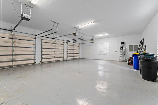 garage featuring electric panel and a garage door opener