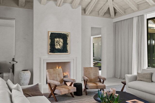 living room with beam ceiling, wood ceiling, and high vaulted ceiling