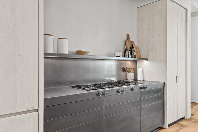 kitchen with stainless steel gas stovetop and light wood-type flooring