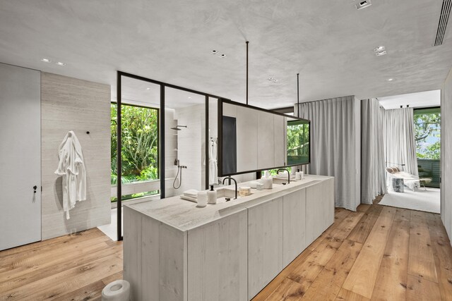 kitchen with floor to ceiling windows, plenty of natural light, and light wood-type flooring