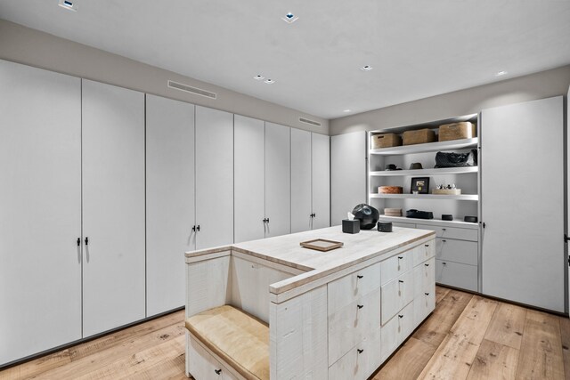 kitchen with white cabinetry and light hardwood / wood-style flooring