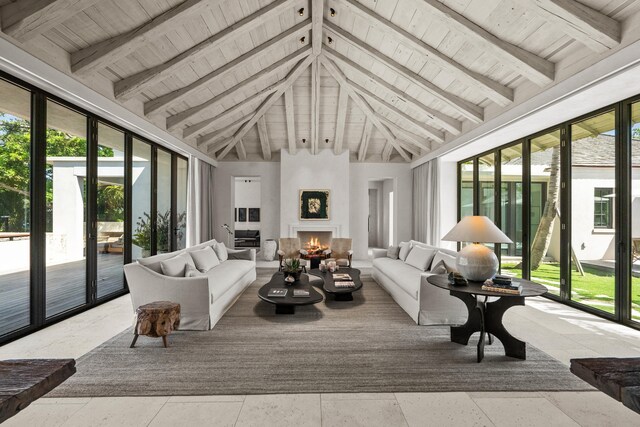 sunroom featuring lofted ceiling with beams, a fireplace, and wooden ceiling