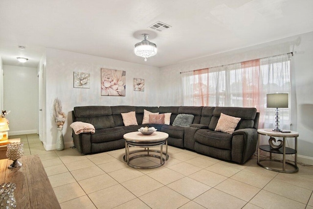 living room featuring a chandelier and light tile patterned flooring