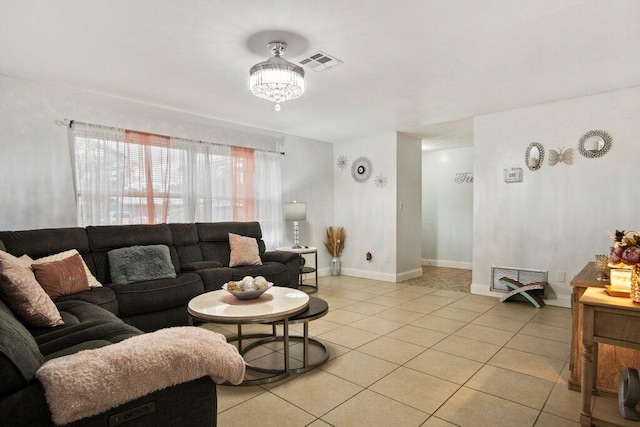 living room featuring light tile patterned floors and an inviting chandelier