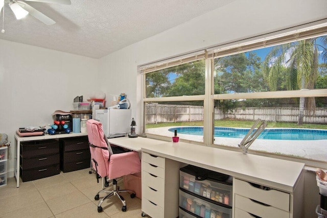 tiled office featuring ceiling fan and a textured ceiling